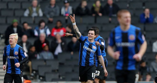 Chris Dagnall: Celebrates after opening the scoring for Barnsley at MK Dons