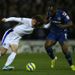 Nikica Jelavic tussles for the ball with Jean-Yves M'voto