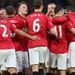 Manchester United celebrate after Ryan Giggs scores the opening goal in their 2-0 win over Everton, which stretches their lead to 12 points.