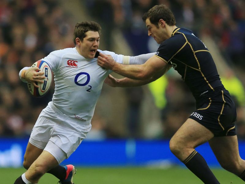 Giving their all: Alex Goode of England holds off Scotland's Tim Visser