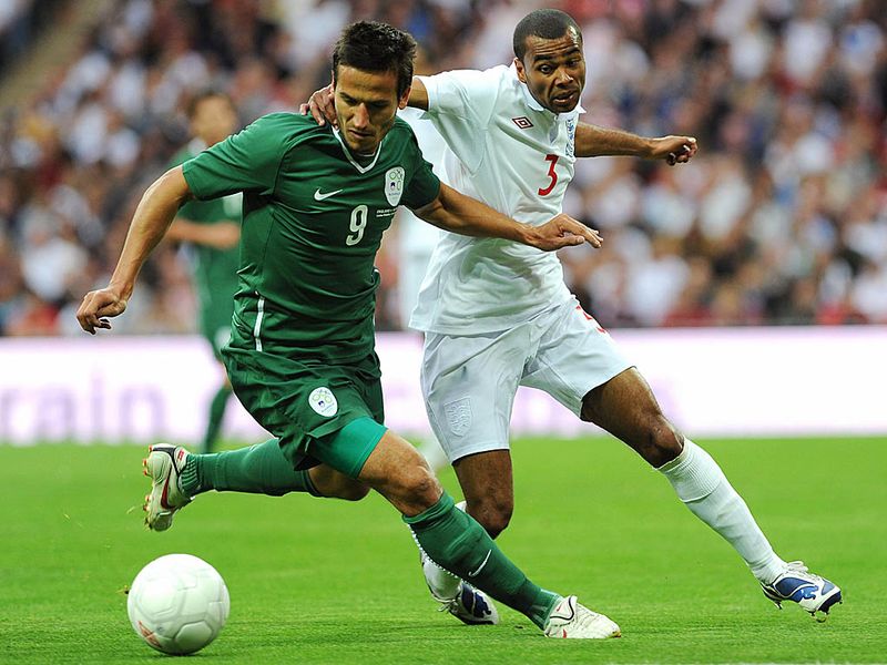 Ashley Cole celebrates his 75th cap along with Steven Gerrard when England beat Slovenia 2-1 in 2009.