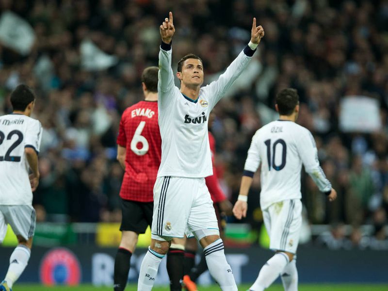 Cristiano Ronaldo raises his arms in celebration after scoring Real Madrid's equaliser against his former club Manchester United
