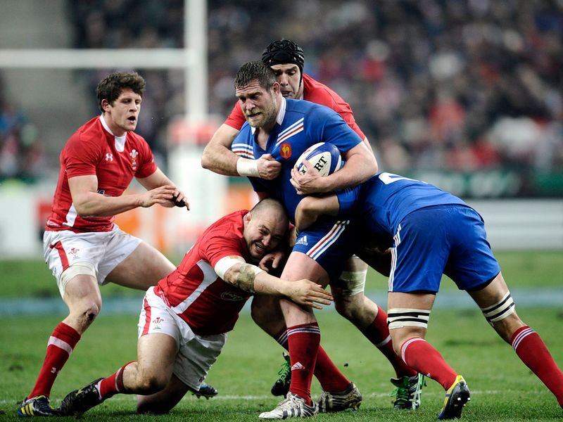 Not such a perfect day: French hooker Benjamin Kayser is tackled by Wales lock Lou Reed