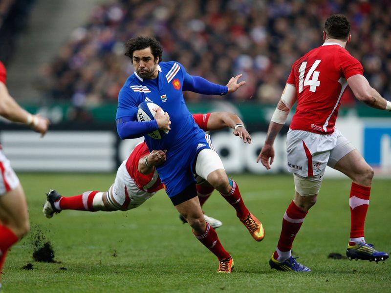 Run halted: Yoann Huget is tackled by Toby Faletau