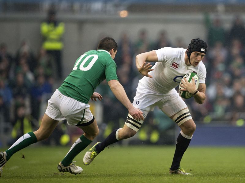 Hand off: England's Tom Wood tries to keep Jonathan Sexton at bay