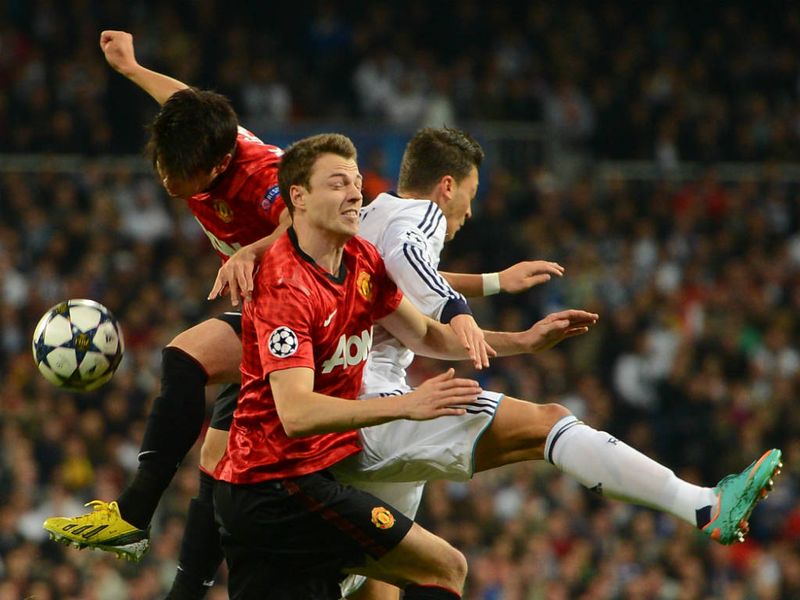 Manchester United duo Jonny Evans and Shinji Kagawa challenge for the ball