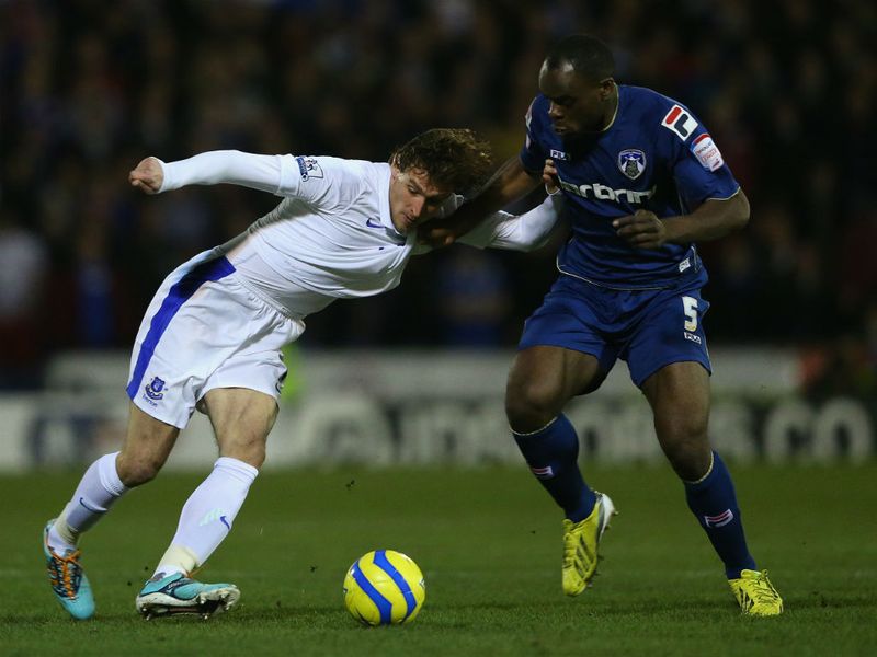 Nikica Jelavic tussles for the ball with Jean-Yves M'voto