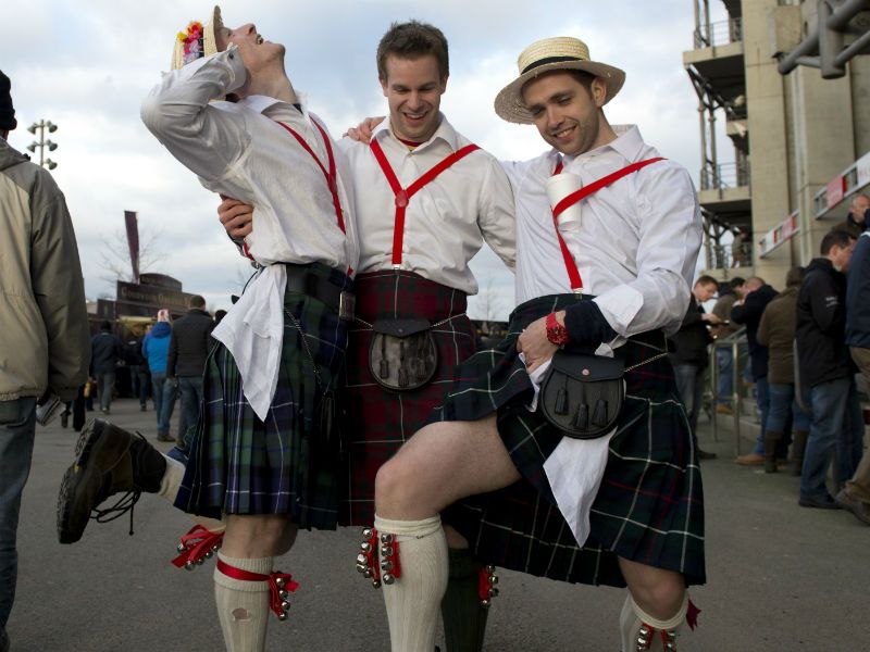 Good spirits: Scotland fans in kilts strike a pose before the match