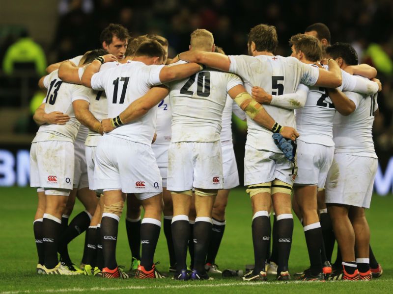 Team bonding: The England team huddle after the RBS Six Nations match