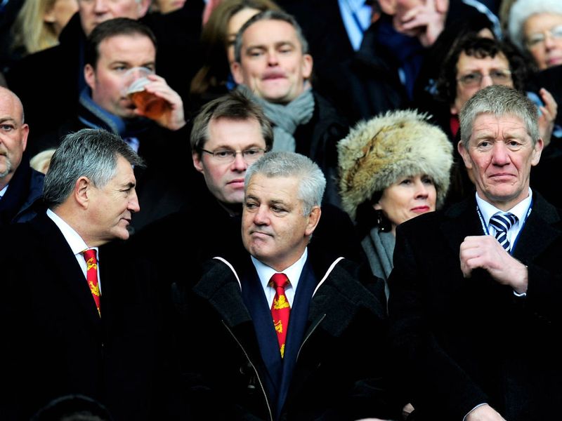 British and Irish Lions head coach Warren Gatland (c) watches the match with Scotland legends Andy Irvine and John Jeffrey