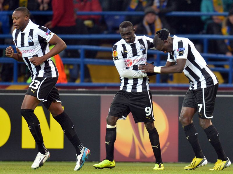 Newcastle booked a spot in the last 16 as Shola Ameobi's second-half penalty fired them past Metalist Kharkiv.