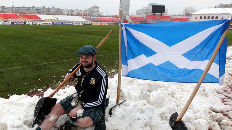 Scotland supporters helped clear the snow-covered pitch in Novi Sad