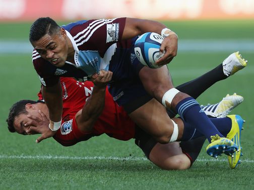 Francis Saili of the Blues fends off Dan Carter