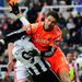Goalkeeper Asmir Bergovic takes out man and ball