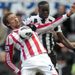 Peter Crouch is challenged by Mapou Yanga-Mbiwa