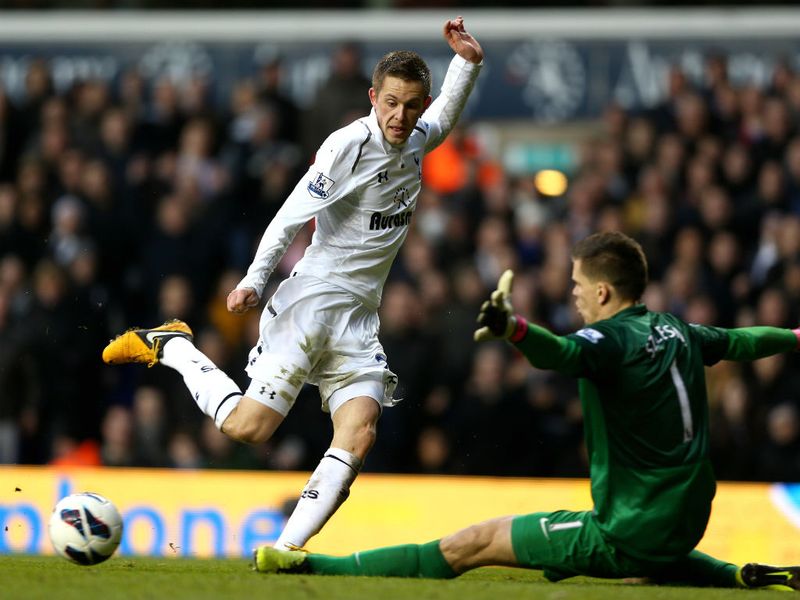 Gylfi Sigurdsson is put off by the giant frame of Szczesny as his shot drifts across the face of goal