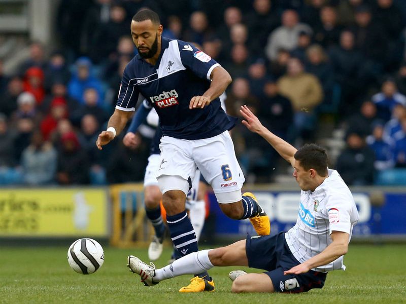 Jason Lowe slides in to make a tackle on Liam Trotter