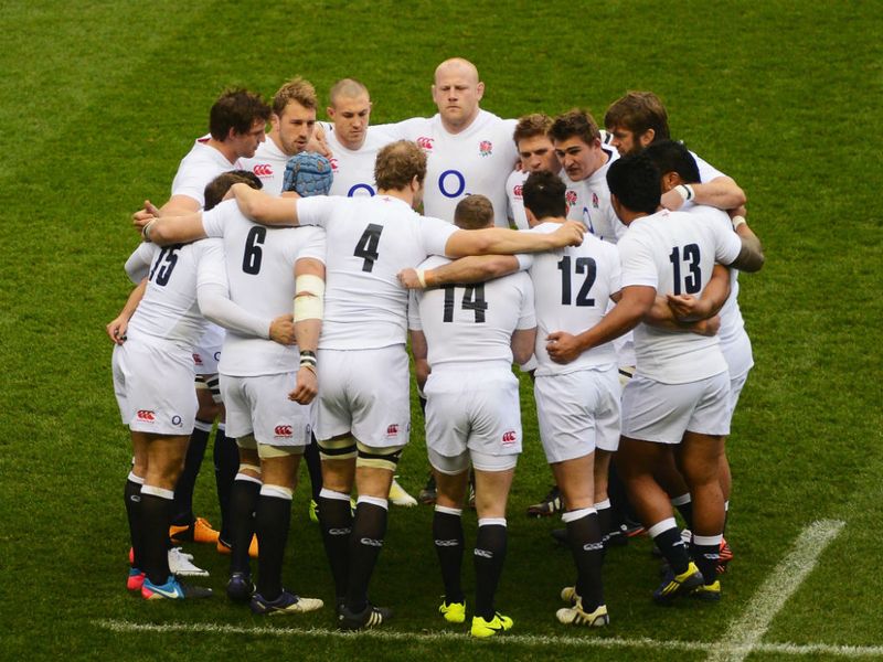 Team bonding: The England team huddle ahead of the Six Nations match
