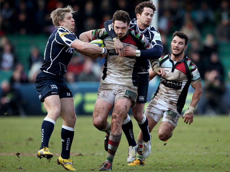 Fully committed: Tom Guest of Harlequins is tackled by Charlie Amesbury and Danny Cipriani