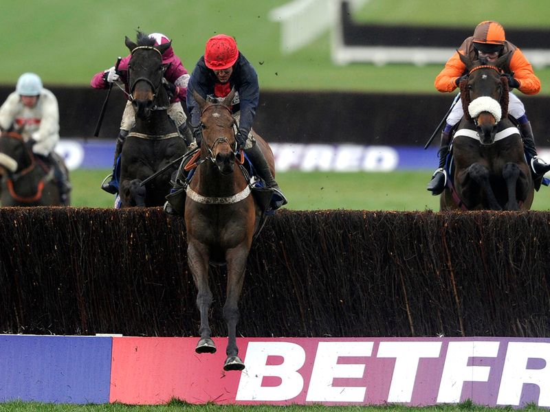 Bobs Worth clears the last ahead of Sir Des Champs (left) and Long Run (right)