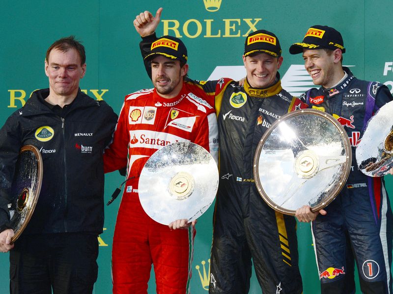 Alan Permane, Fernando Alonso, Kimi Raikkonen and Sebastian Vettel on the podium
