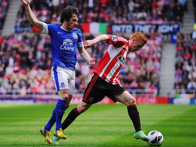Jack Colback of Sunderland holds off Leighton Baines