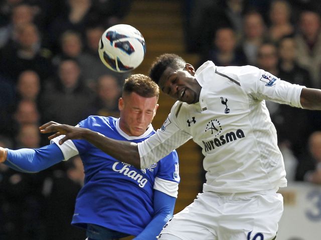 Ross Barkley and Emmanuel Adebayor go for a header