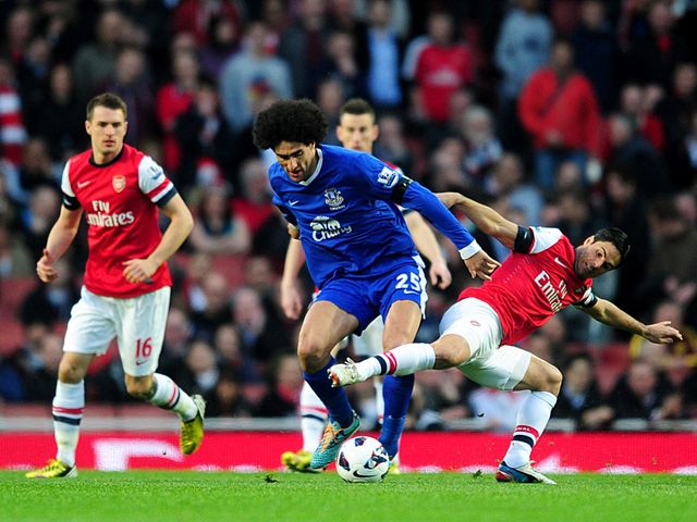 Marouane Fellaini and Mikel Arteta battle for the ball.