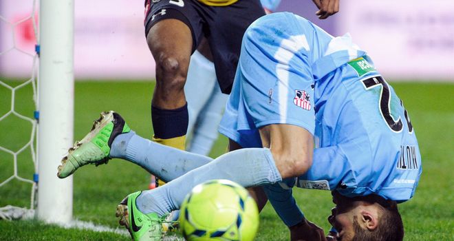 Ajaccio's Adrian Mutu takes a tumble