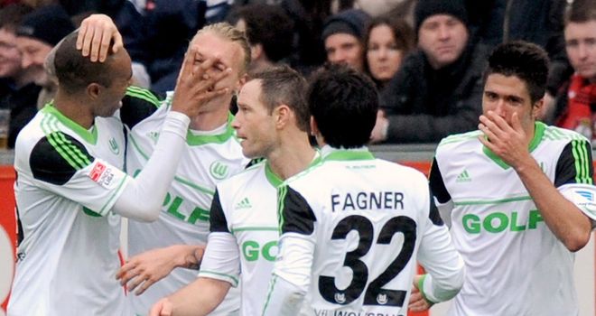 Simon Kjaer is mobbed following Wolfsburg's equaliser