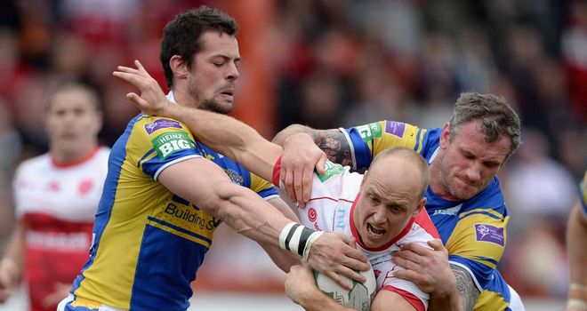 Michael Dobson is tackled by Ian Kirke and Jamie Peacock