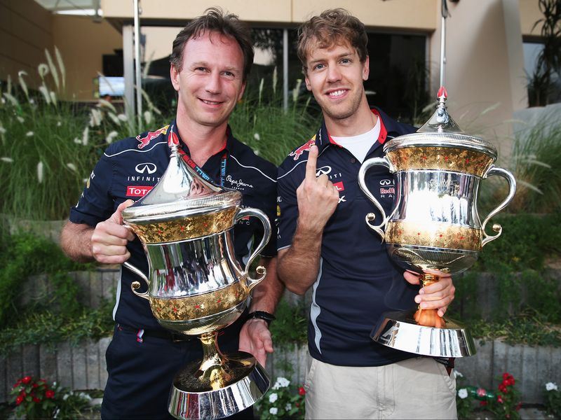 Sebastian Vettel and Christian Horner show off their trophies