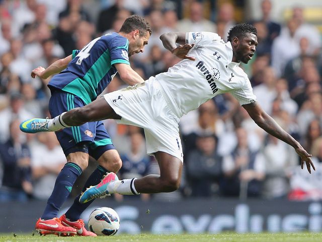 Emmanuel Adebayor takes a tumble.