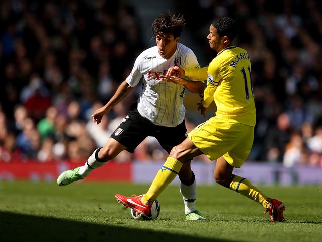 Bryan Ruiz and Jobi McAnuff compete.