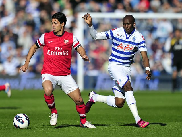 Mikel Arteta vies with Stephane Mbia.