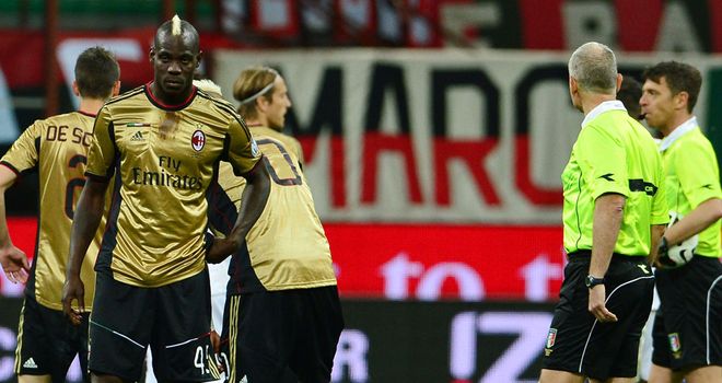 Balotelli and his AC Milan team-mates wait for Sunday's match to be restarted