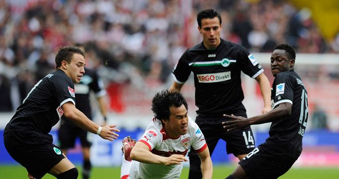 Shinji Okazaki of Stuttgart takes a tumble