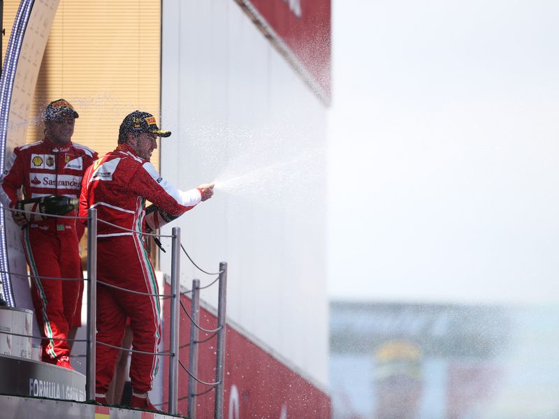 Fernando Alonso sprays the champagne