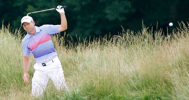 Sergio Garcia hacks out of rough at the 12th prior to his horror show at 15