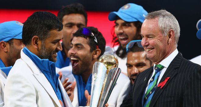 MS Dhoni collects the trophy after his side's five-run victory in the final