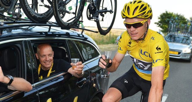 Celebrate: Froome enjoys a sip of champagne with Dave Brailsford