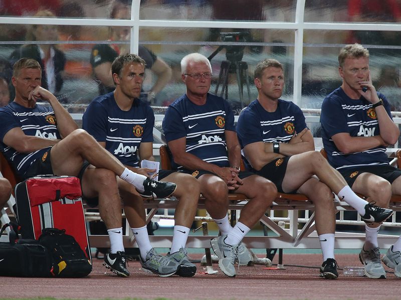 Moyes and his coaching team watch as United labour in Bangkok