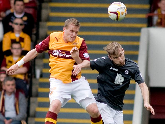 Steven Hammell wins an aerial challenge against Gary Fraser.