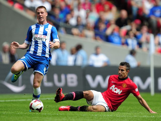 Van Persie slides in on McCarthy.