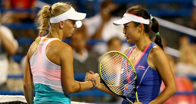 Caroline Wozniacki shakes hands with Peng Shuai at the New Haven Open