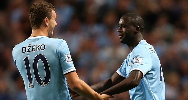 Yaya Toure celebrates with Edin Dzeko after his free-kick made it 3-0