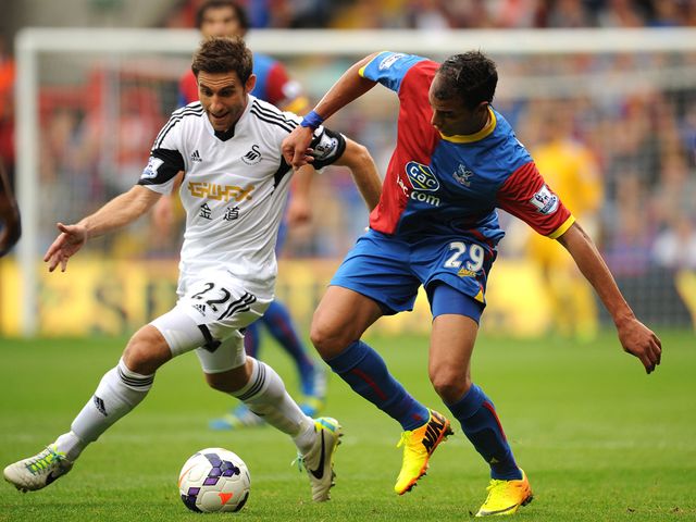 Angel Rangel and Marouane Chamakh battle for the ball
