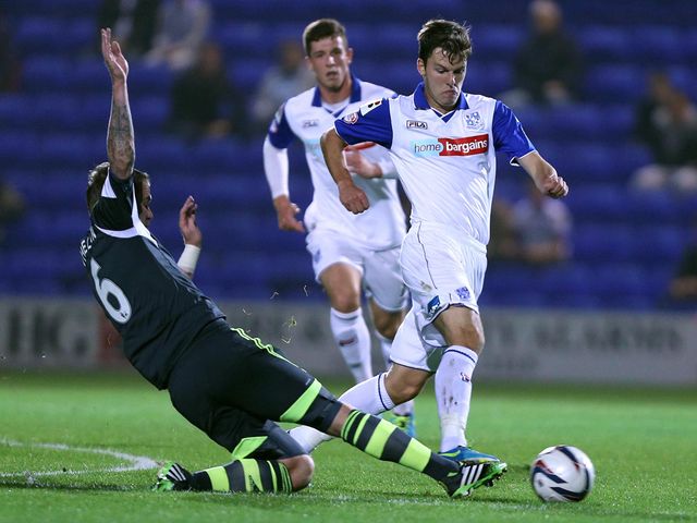 Chris Atkinson tries to escape Glenn Whelan's challenge.