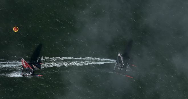 Oracle (right) prepare to round the buoy ahead of Team New Zealand