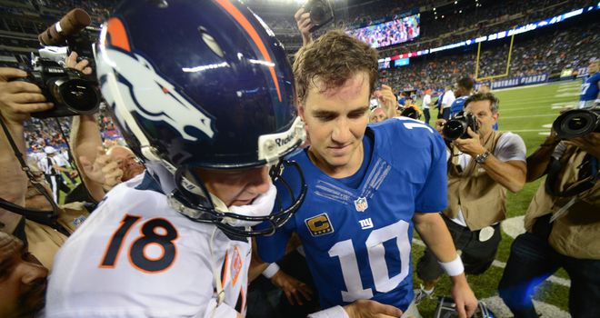 Peyton Manning (left) shakes hands with his brother Eli